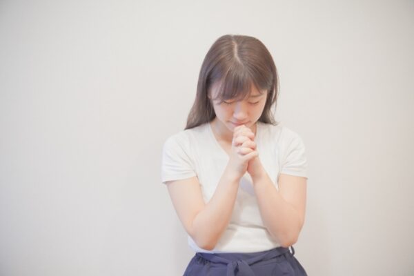 女性がお祈りしている画像